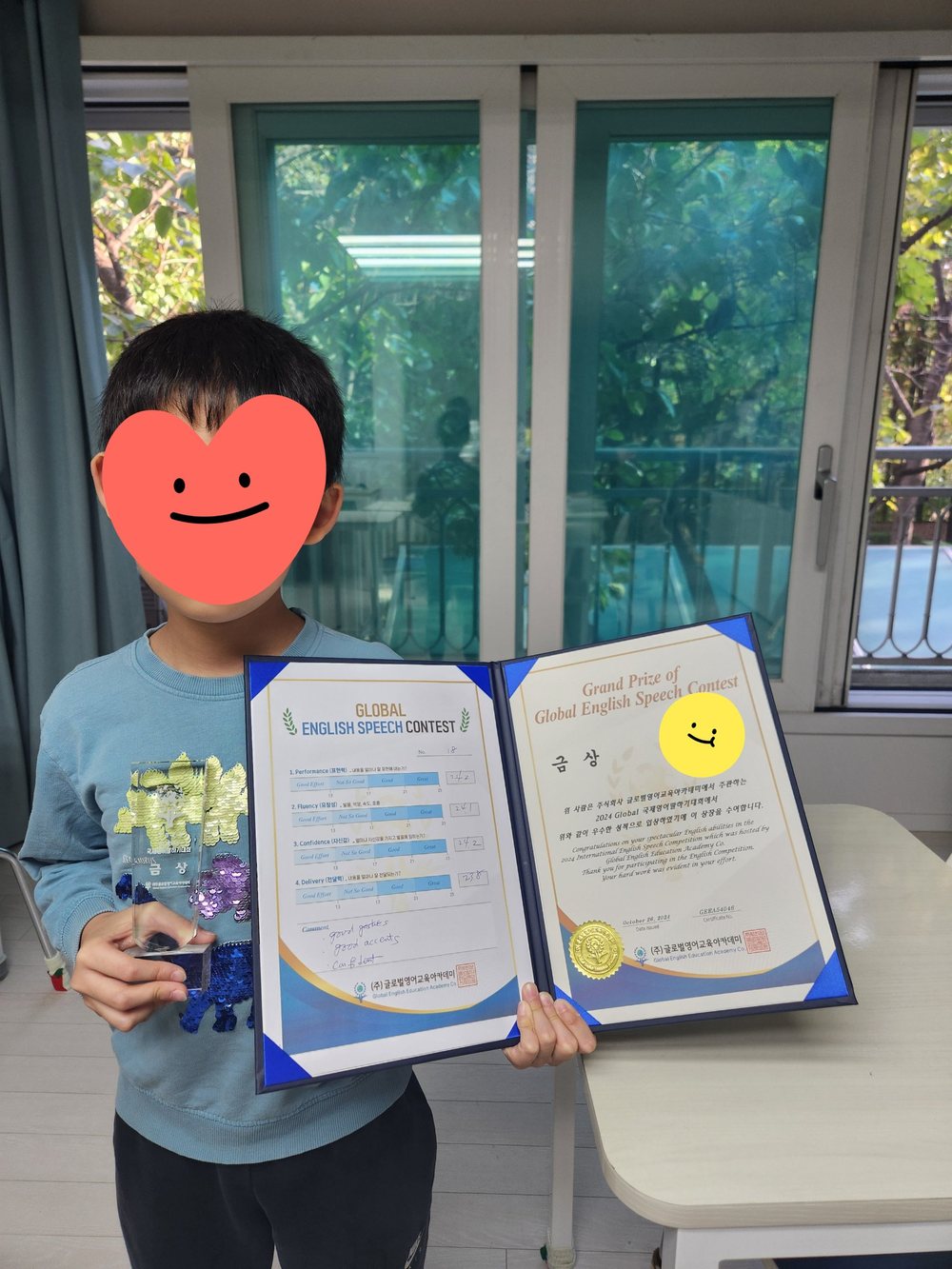 말하기 대회 금상 트로피와 상장을 든 학생
